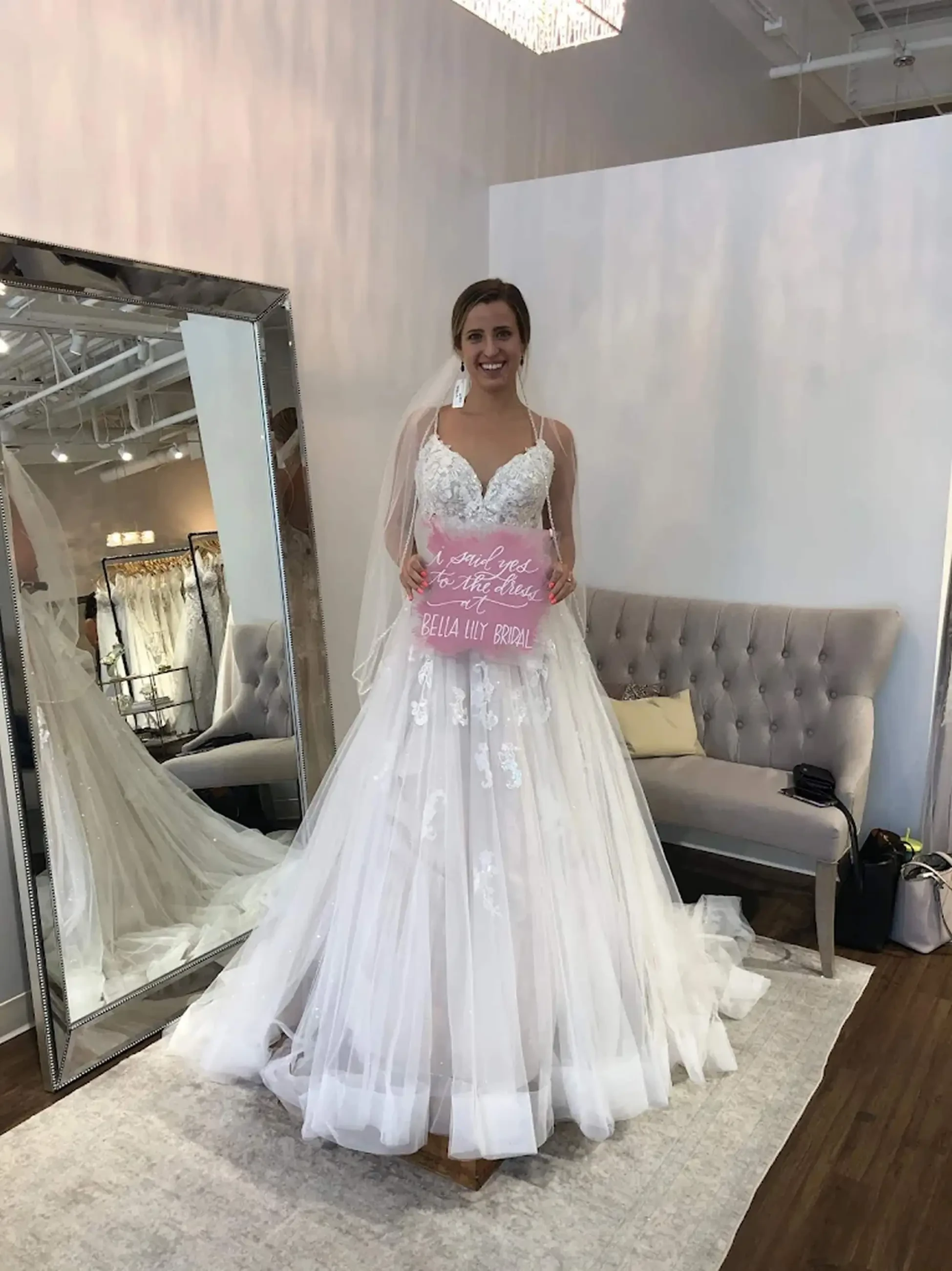 model is wearing a sleeveless a-line lace bridal gown