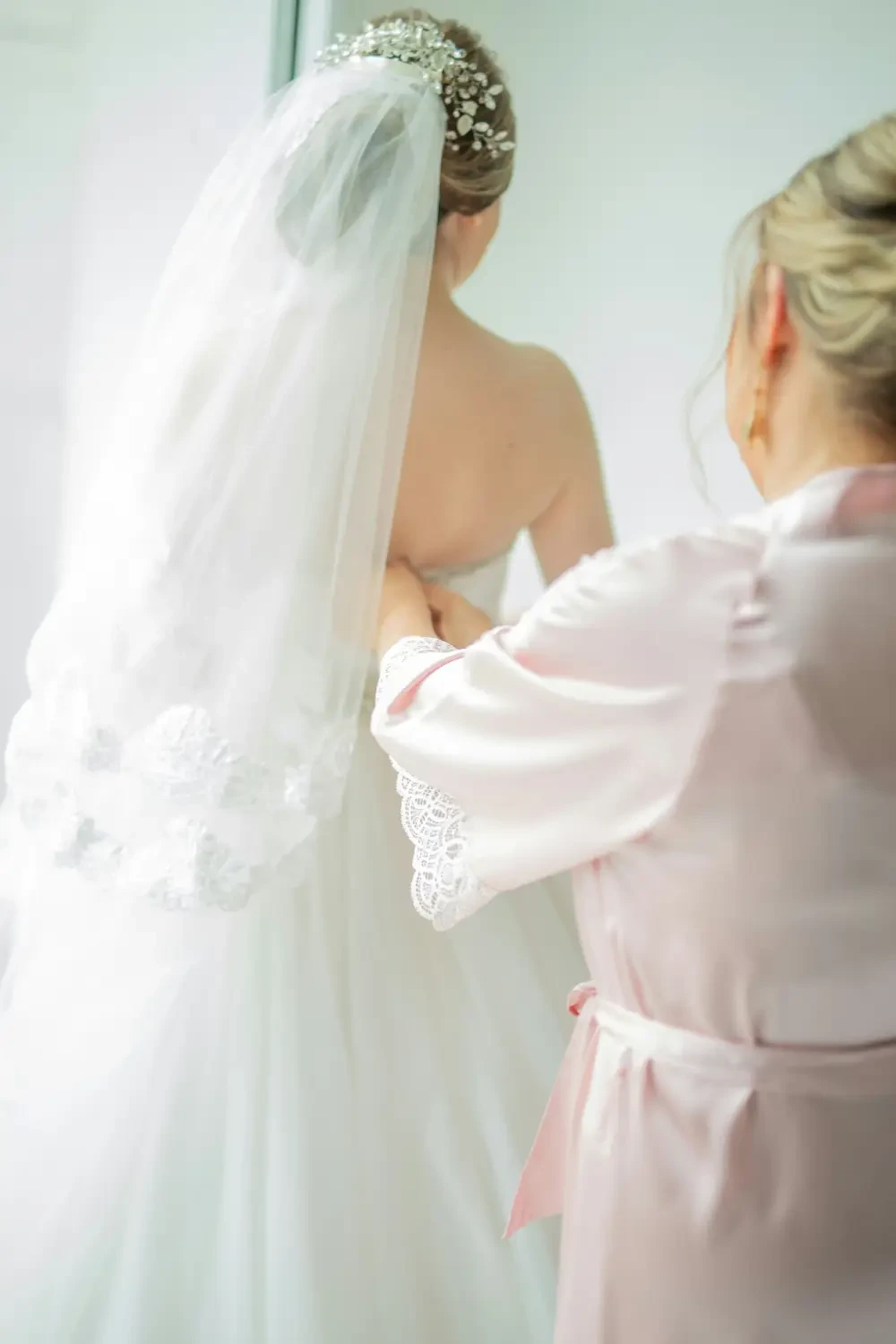 image shows a bride wearing her open back wedding dress on her big day